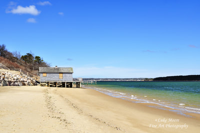 Sunny, vivid seascape photograph of a quiet, little beach in Chatham, Massachusetts, MA Cape Cod. This beach is located near Allen Point, between Chatham Harbor and Pleasant Bay. The Atlantic Ocean and the Chatham Lighthouse are not far from this scenic beach. 