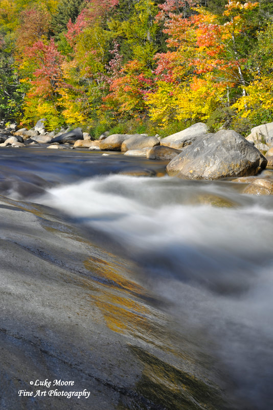 Colorful fall foliage at Lower Falls, Kancamagus Highway in New Hampshire. 