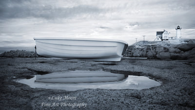 Landscape infrared photograph of The Nubble Lighthouse and a rowboat  at Cape Neddick in York, Maine. Photography prints available for wall decor and wall art. 
