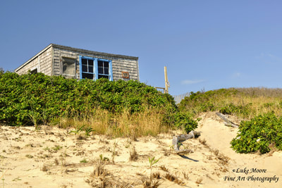 A July, landscape photograph of the Margo Gelb beach cabin in Provincetown, Massachusetts, Cape Cod. This dune shack is the essence of simple, rustic living. A perfect spot nestled in the dunes for that beach retreat or artist sabbatical. A great addition to your collection of beach house decor. Please visit my Fine Art America or Pixels websites for more Cape Cod beach photography. 