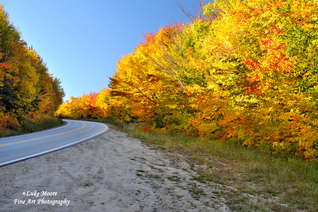 Colorful fall foliage on Kancamagus Highway in Lincoln, New Hampshire.  Fine art prints and wall decor by Luke Moore. Picture